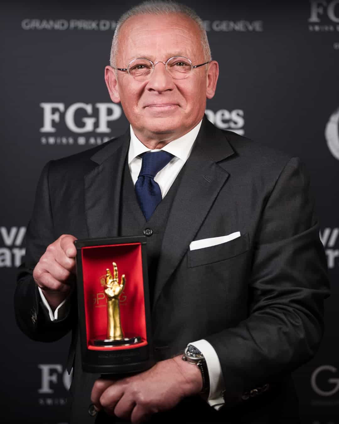 Elegant gentleman holding Bovet timepiece awarded at GPHG 2025, luxury craftsmanship.